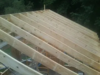New roof rafters set over an addition before sheathing in Mcmechen